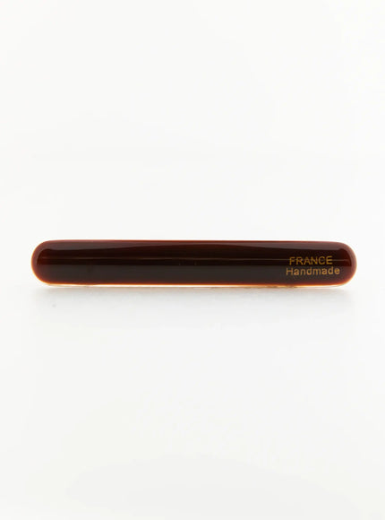 Rosie One Hair Clip IL503 Brown front view flat-lay, elongated dark brown glossy resin body with France Handmade gold stamp