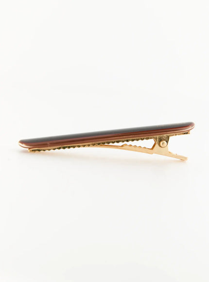 Rosie One Hair Clip IL503 Brown side view showing open alligator clip, dark brown resin top with gold-tone serrated metal jaw