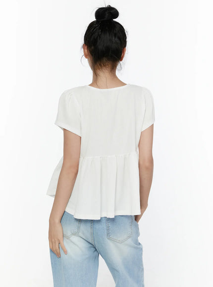 Round Neck Shirred Short Sleeve Top CL520 White back shot on model showing clean back panel cap sleeves gathered empire waist seam and flared peplum hem