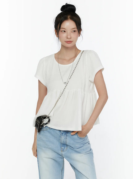 LEWKIN Round Neck Shirred Short Sleeve Top CL520 White front shot on model wearing bun updo styled with light blue wide-leg jeans and black chain crossbody bag