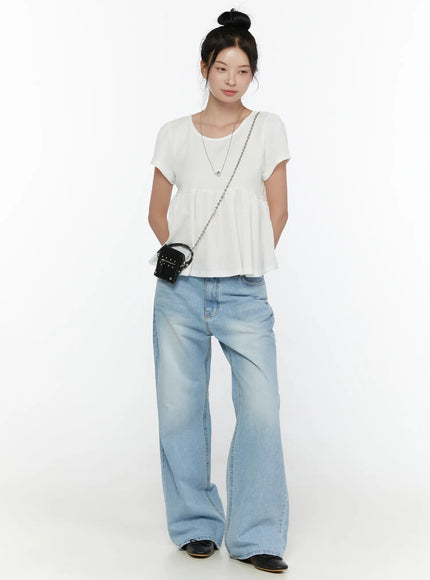 Round Neck Shirred Short Sleeve Top CL520 White full-body front shot on model with bun hair styled with wide-leg light wash jeans and chain bag showing overall silhouette