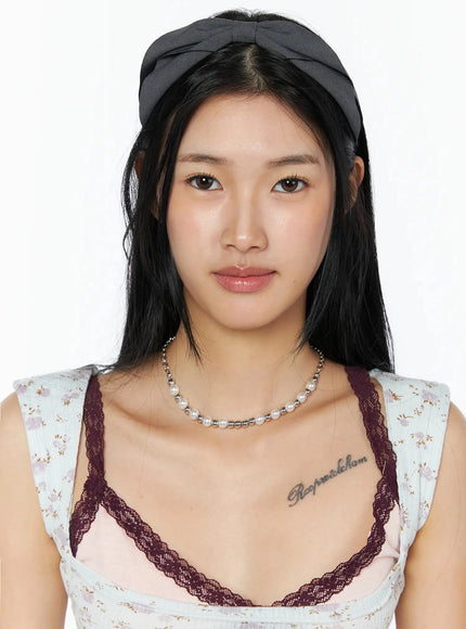 LEWKIN Ruched Bow Headband IL509 Dark gray close-up front on model with bow knot detail centered on head, paired with pearl necklace and floral top