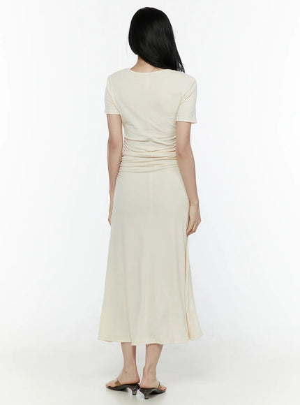 Ruched Maxi Dress IL506 Light beige back full-body model shot showing back ruching detail at waist and flared maxi hem with kitten heel mules