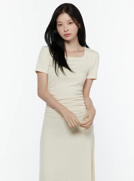 Ruched Maxi Dress IL506 Light beige front model shot hands clasped showing square neckline fitted silhouette and maxi length with kitten heel mules