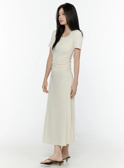 Ruched Maxi Dress IL506 Light beige side model shot showing full-length silhouette ruched waist panel and A-line maxi skirt with kitten heel mules