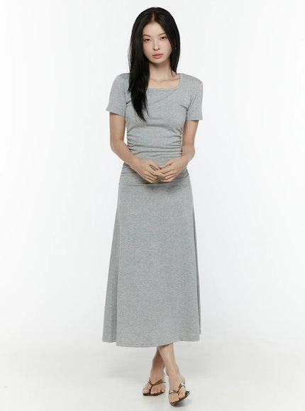 Ruched Maxi Dress IL506 Grey front full-body model shot hands clasped square neckline short sleeves side ruching and flared maxi skirt with thong sandals