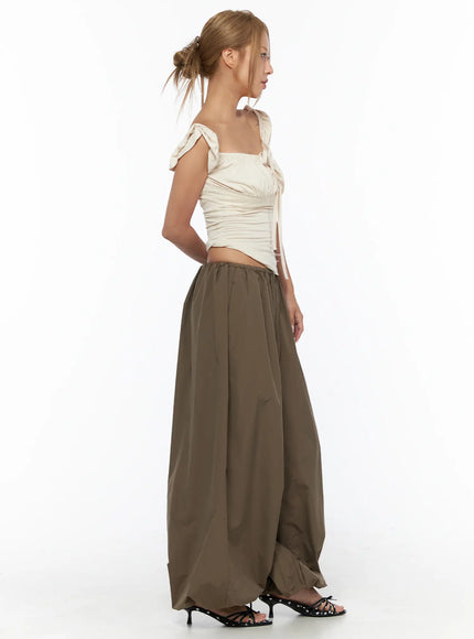 Ruched Off-Shoulder Bow Detail Top CU524 light beige side shot on model showing ruched bodice bow shoulder ties and fitted waist silhouette