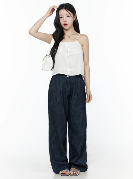 Ruched Ribbon Cami Top IU525 White full-length front shot on model styled with white shoulder bag and wide-leg dark denim trousers silver sandals