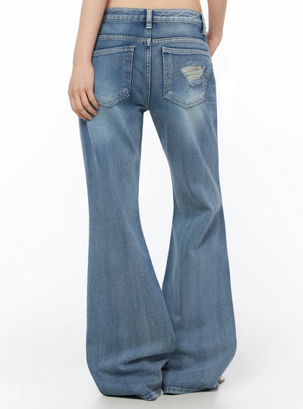 Rue Distressed Bootcut Flare Jeans IU525 Blue back crop shot on model showing back pockets, center seam, and small frayed distressing on right pocket