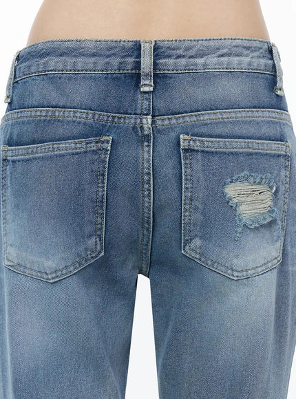 Rue Distressed Bootcut Flare Jeans IU525 Blue close-up detail of back waistband and dual back pockets with frayed distressing on right pocket