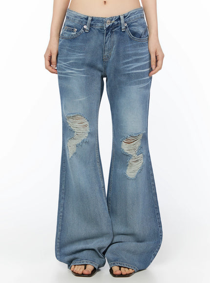 LEWKIN Rue Distressed Bootcut Flare Jeans IU525 Blue front crop shot on model showing low-rise waistband, silver button hardware, and large knee distressing