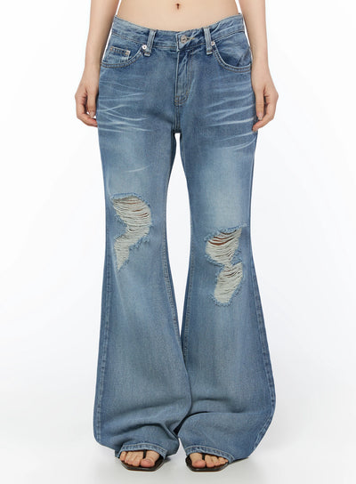 LEWKIN Rue Distressed Bootcut Flare Jeans IU525 Blue front crop shot on model showing low-rise waistband, silver button hardware, and large knee distressing