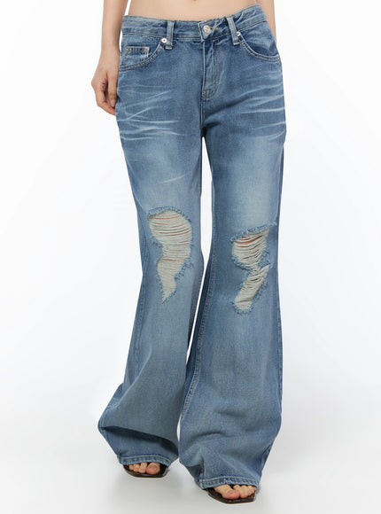 Rue Distressed Bootcut Flare Jeans IU525 Blue front crop shot on model showing dual large frayed knee rips, low-rise waistband, and bootcut flare
