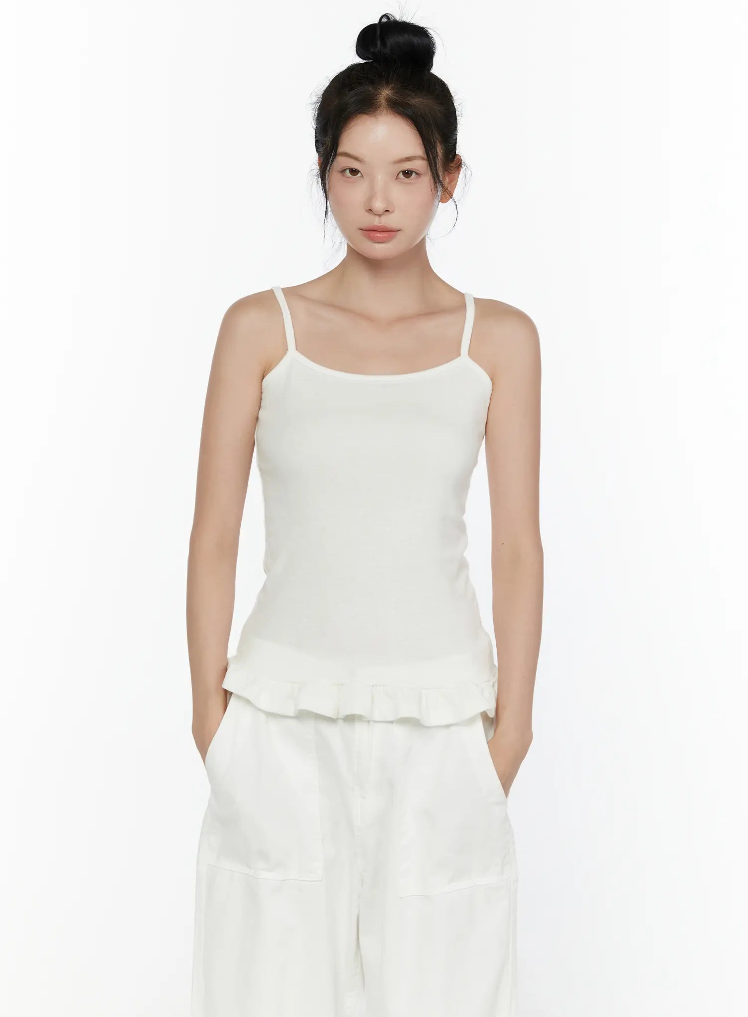 Ruffle Detail Cami Top CL521 White front shot on model waist-up, clean square neckline, spaghetti straps, slim ribbed knit fit, ruffled peplum hem visible against white background