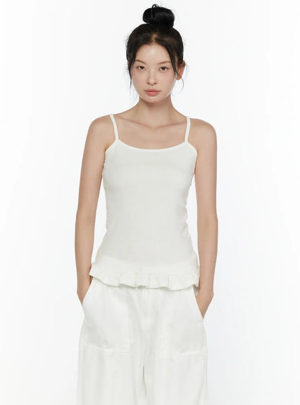 Ruffle Detail Cami Top CL521 White front shot on model waist-up, clean square neckline, spaghetti straps, slim ribbed knit fit, ruffled peplum hem visible against white background