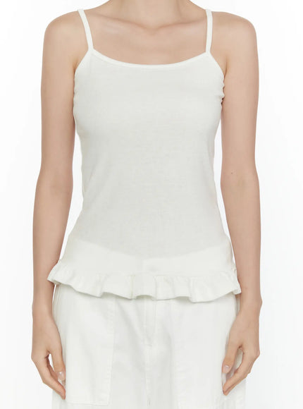 Ruffle Detail Cami Top CL521 White close-up front shot on model, spaghetti straps, square neckline, ribbed texture detail, fitted bodice with ruffle hem, no accessories
