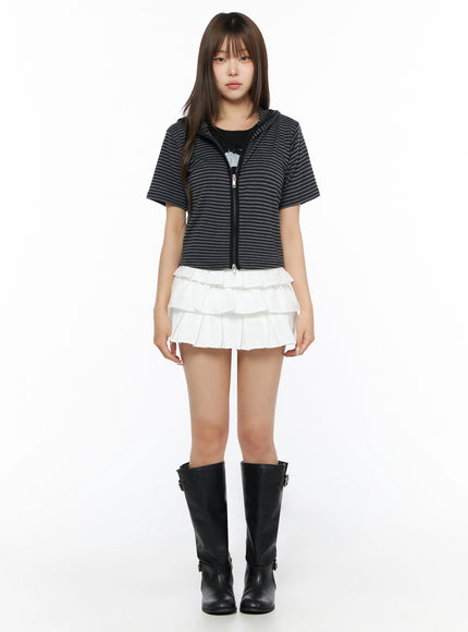 Ruffle Detail Mini Skirt IL523 White full-body front shot on model in standing pose, styled with striped zip-up hoodie and black knee-high boots