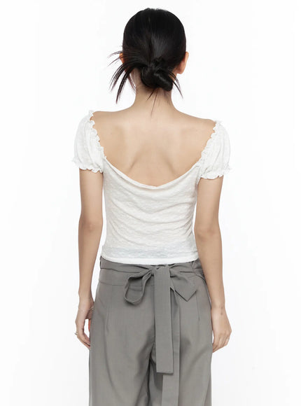 Ruffle Detailed Blouse CL527 White back model shot revealing deep scoop back neckline, ruffle-edged puff sleeves, paired with gray tie-waist trousers