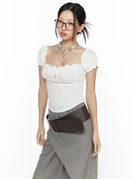 LEWKIN Ruffle Detailed Blouse CL527 White S/M front model shot wearing glasses with layered necklace and brown leather belt, textured puff sleeve top