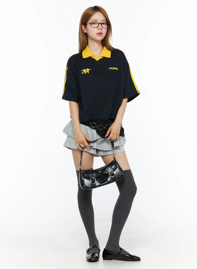 LEWKIN Ruffle Hem Mini Skort CL502 Gray S full-body front model shot styled with navy polo top dark knee-high socks and black patent flats