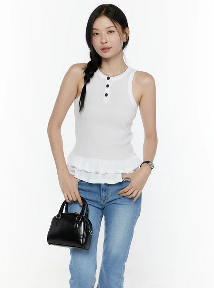 LEWKIN Ruffle Hem Tank Top IL506 White S/M front shot on model standing with black mini bag, ribbed knit fabric with black buttons and double ruffle hem, styled with blue jeans