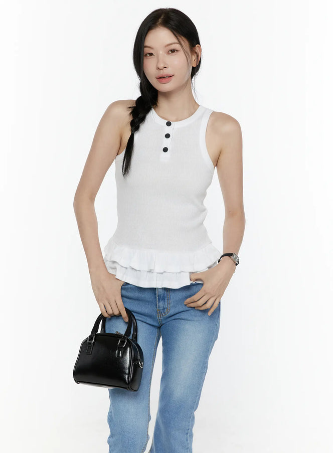 LEWKIN Ruffle Hem Tank Top IL506 White S/M front shot on model standing with black mini bag, ribbed knit fabric with black buttons and double ruffle hem, styled with blue jeans