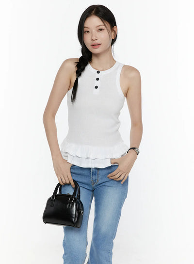 LEWKIN Ruffle Hem Tank Top IL506 White S/M front shot on model standing with black mini bag, ribbed knit fabric with black buttons and double ruffle hem, styled with blue jeans