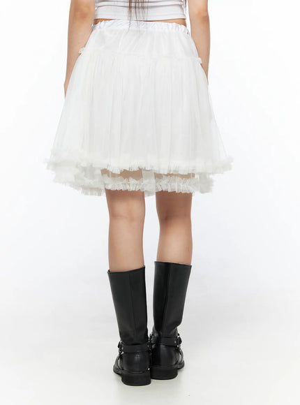 Ruffle Layered Midi Skirt CL517 White back shot on model showing rear elastic waistband full tulle volume and frayed ruffle hem with black boots
