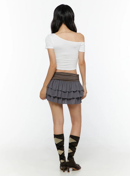 Ruffle Layered Mini Skirt CU529 Brown full back on model wearing gray layered ruffle mini skirt with brown fold-over waistband styled with white off-shoulder crop top and argyle knee-high socks