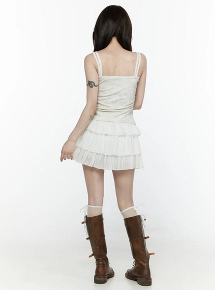 Ruffle Layered Mini Skirt IL521 White back view on model showing three-tier pleated ruffle layers with white tank top and brown knee-high combat boots