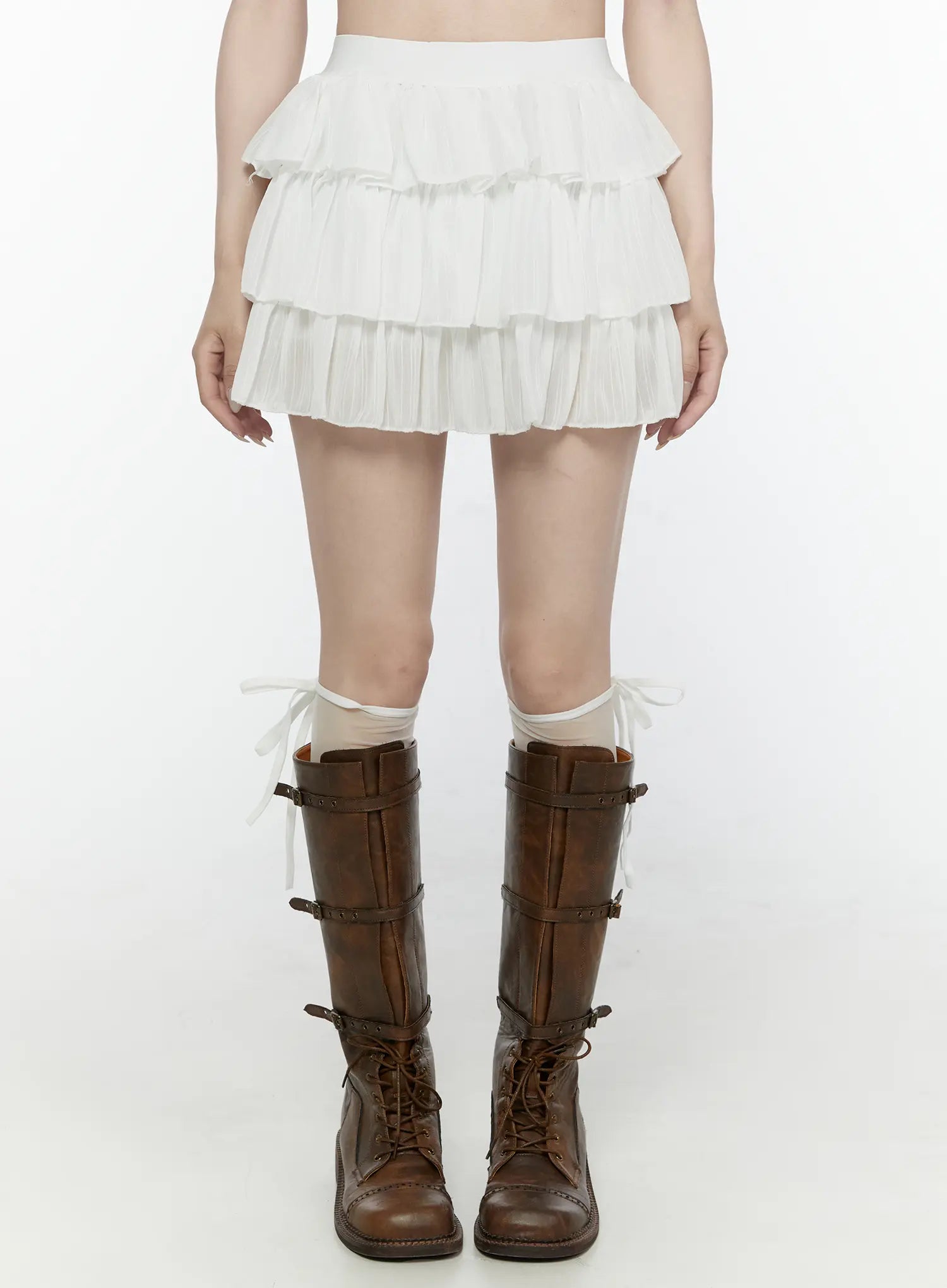 LEWKIN Ruffle Layered Mini Skirt IL521 White front view on model wearing brown combat boots and sheer socks, S/M, pleated three-tier mini skirt
