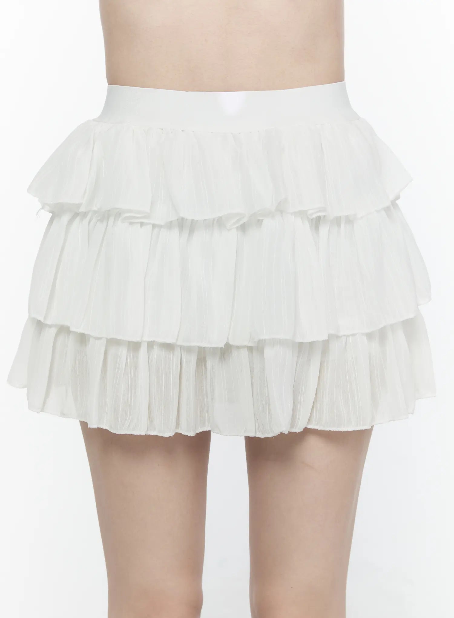 Ruffle Layered Mini Skirt IL521 White close-up front view on model showing three-tier pleated chiffon ruffle texture and wide elastic waistband