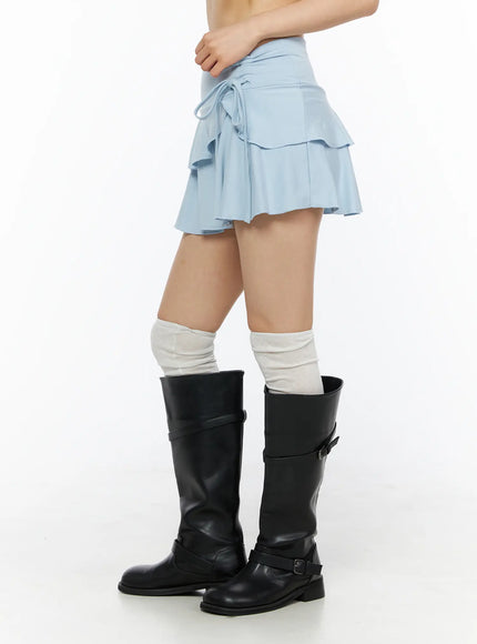 Ruffle Mini Skirt CL501 Light blue side shot on model revealing ruffle tier layers and side string tie with black knee boots