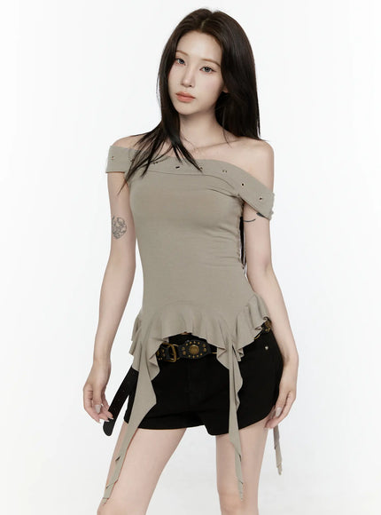 Ruffle Off-Shoulder Top IL521 Dark green three-quarter front model shot hands relaxed asymmetric ruffle peplum hem gold eyelet off-shoulder neckline detail