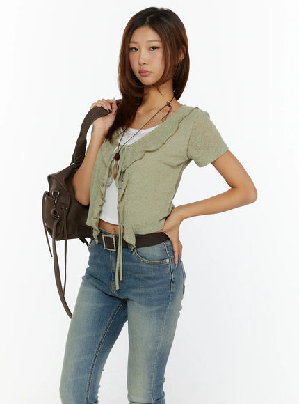 LEWKIN Ruffle Tie Cardigan CL515 Dark green S/M front shot on model styled with jeans and brown shoulder bag, short-sleeve ruffle tie knit crop top