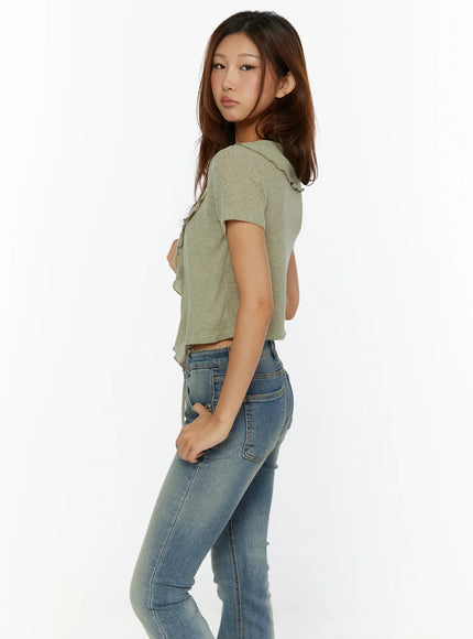 Ruffle Tie Cardigan CL515 dark green side shot on model in skinny jeans hand in pocket, showing cropped silhouette and ruffle-trimmed front opening