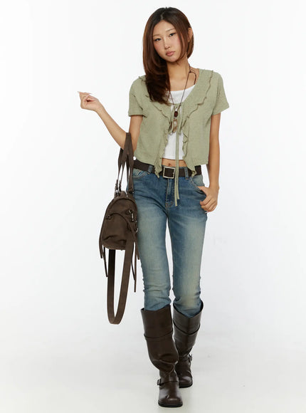 Ruffle Tie Cardigan CL515 dark green front full-body shot on model with brown bag and boots, ruffle tie cardigan layered over white tank with belt
