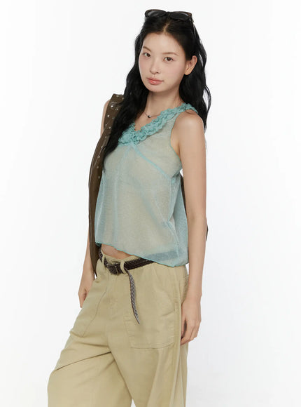 Ruffle V-Neck Sleeveless Top CL521 Mint three-quarter front shot on model with sunglasses on head and brown studded bag showing sheer top with braided belt
