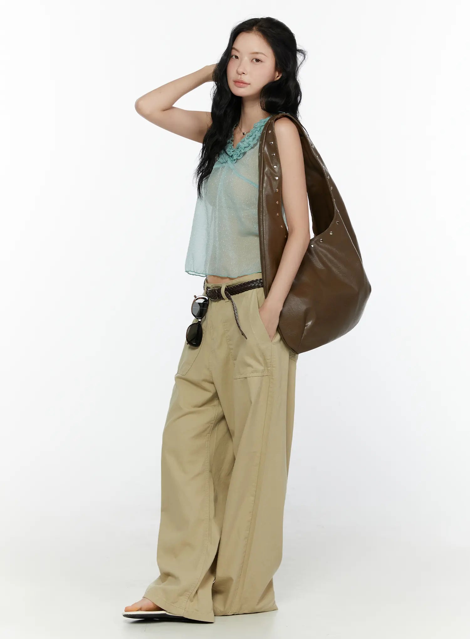 Ruffle V-Neck Sleeveless Top CL521 Mint full-body side shot on model with hand on hair carrying brown studded bag styled with khaki trousers