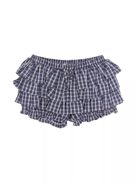 Ruffled Plaid Skort IL506 Dark blue flat-lay front view showing triple-tiered ruffle layers, elastic waistband, grommet drawstring, and plaid cotton fabric