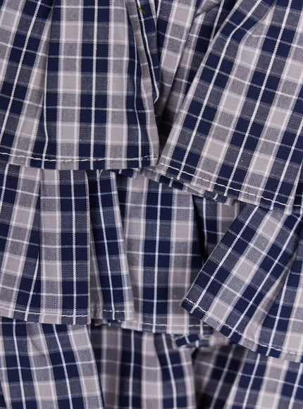 Ruffled Plaid Skort IL506 Dark blue close-up detail shot of tiered ruffle layers showing navy and grey plaid woven cotton fabric texture and frayed hem edges