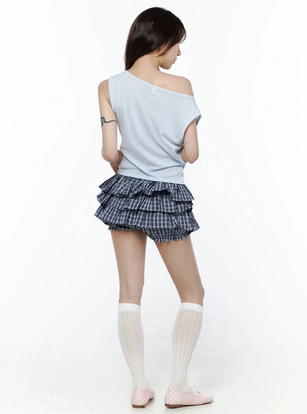 Ruffled Plaid Skort IL506 Dark blue back shot on model wearing light blue off-shoulder top, showing tiered ruffle back detail with white knee-high socks