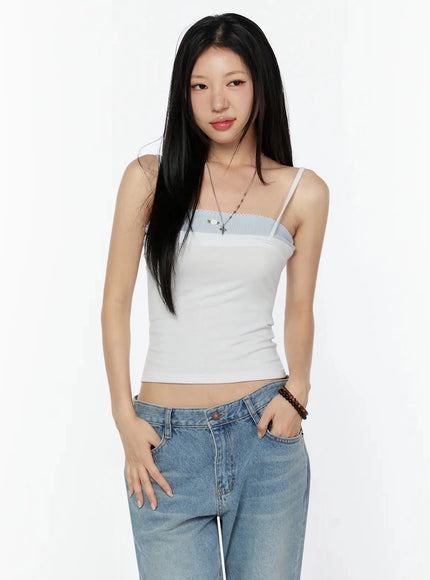 Scallop Trim Layered Cami Top IU524 White S/M cropped front model shot waist-up hands in pockets showing blue scallop trim detail and ribbed white fabric