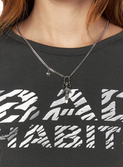 Shadow Sword Necklace IL522 Silver styled on female model wearing dark graphic tee, dagger pendant and floral medallion charm at neckline