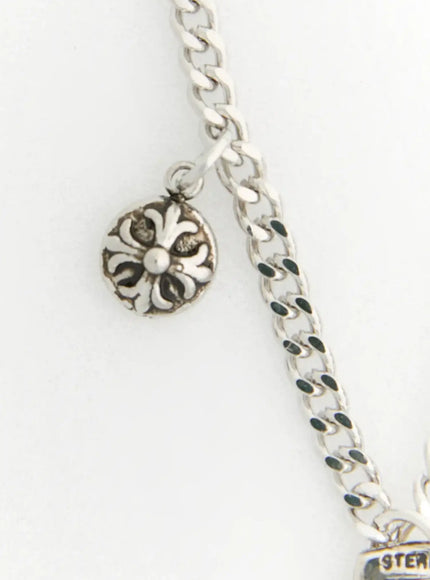 Shadow Sword Necklace IL522 Silver detail of floral medallion charm and curb chain link clasp area on white background