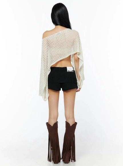 Shawl Crop Knit Top IL506 Light beige back view full-length model showing open back design asymmetric shawl hem open-knit texture and brand label on black shorts
