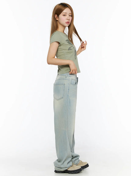 Shawn Washed Wide Leg Jeans CL501 Light blue side shot on model touching hair showing back pocket detail low rise waistband and wide leg drape