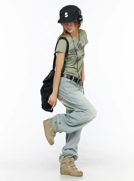 Shawn Washed Wide Leg Jeans CL501 Light blue lifestyle full body shot model wearing cap headphones backpack one leg raised dynamic street style pose
