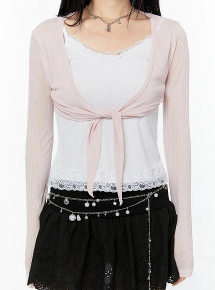 Sheer Front-Tie Wrap Cardigan IU524 Pink close-up detail shot showing front-tie knot, sheer ribbed texture, and lace-hem underlayer