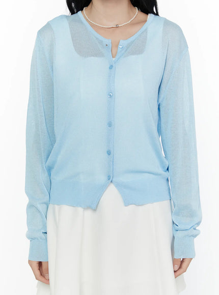 Sheer Knit Cropped Cardigan CL520 Light blue close-up front detail shot on model showing button placket and sheer knit texture with ribbed cuffs